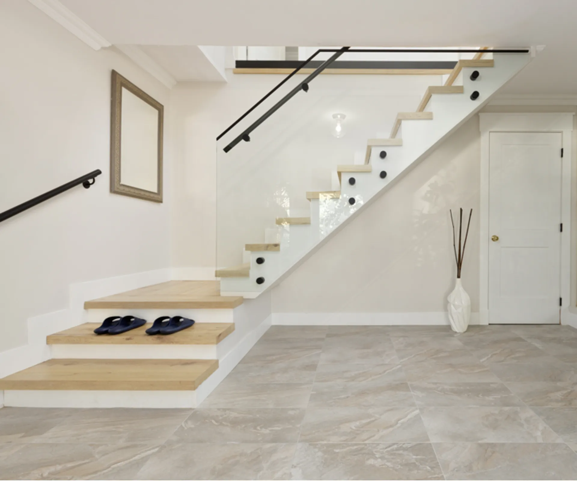 Staircase with wood treads and glass railing after renovation