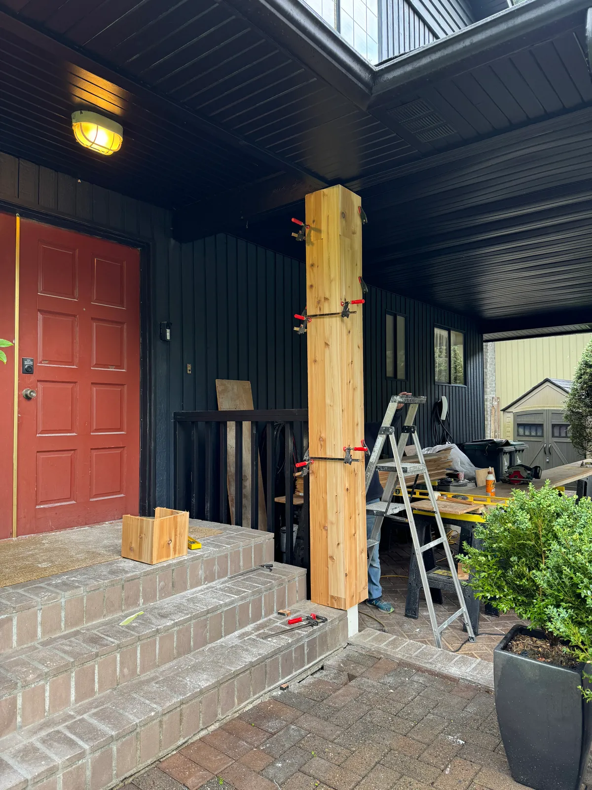 Column wrap held in clamps while trim is assembled